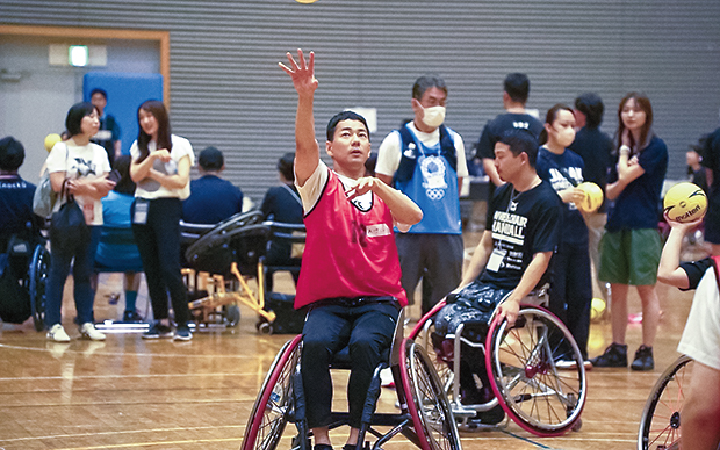 介護施設で高齢者と会話を交わす山本左近